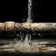 Leaking Rusty Water Pipe Under Pressure Causing Water Damage